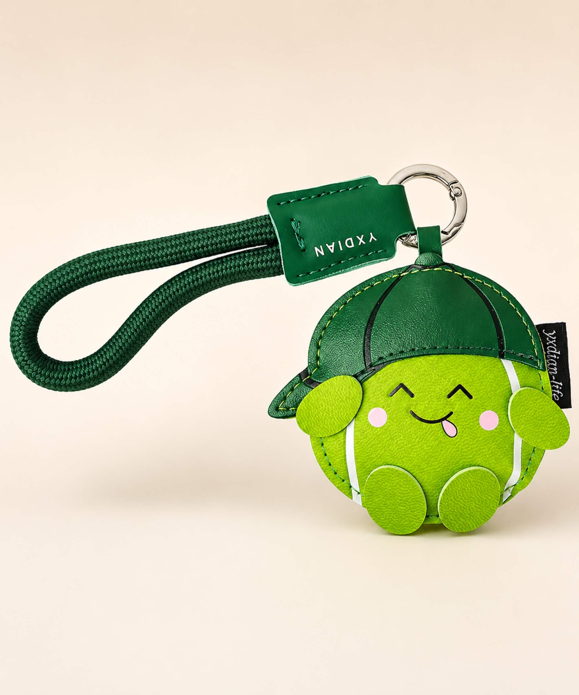 Green tennis PU leather bag charm keychain with wrist strap on a clean neutral background.